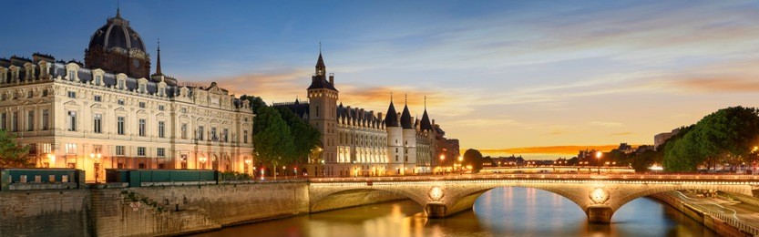 consiergerie, pont neuf and seine river with tour boat at sunny summer sunset, paris, france