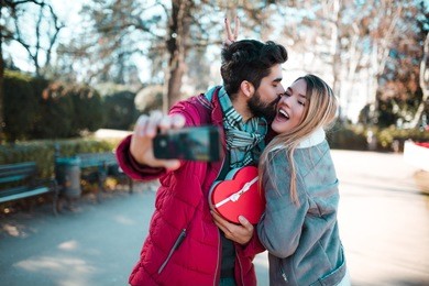 couple making selfie. man surprising his girlfriend with a gift. couple in love. valentine's day.