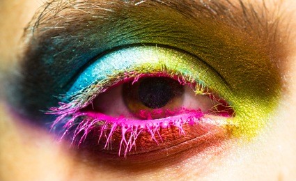 eye with colorful neon paint fashion makeup. holi, paint party, colors festival, indian culture inspired.