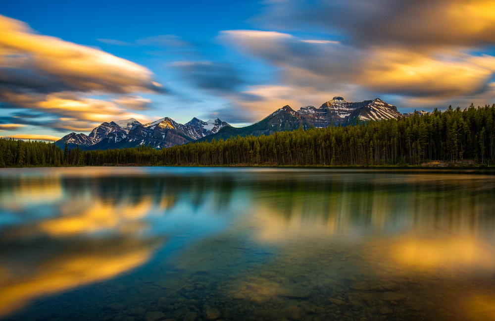 scenic sunset over herbert lake along the roadside of the icefields parkway in banff national park, alberta, canada. long exposure.