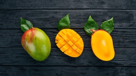 mango. tropical fruits. on a wooden background. top view. copy space.