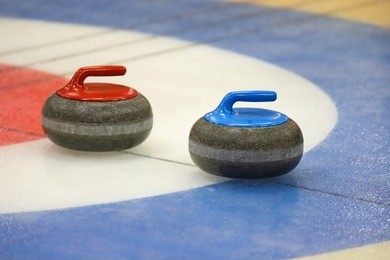 curling stones on ice