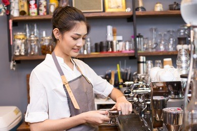 asian barista woman make a coffee at bar. woman success to make coffee.