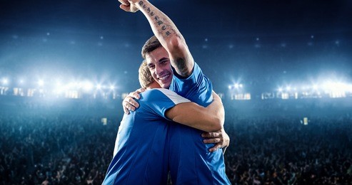 happy soccer player celebrate a victory on a professional football stadium