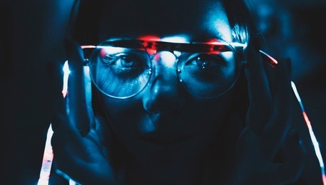 large portrait of girl spectacled. a garland lies on glasses