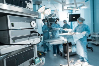 four surgeons preparing in operating room