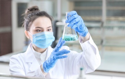 female scientist looking at the scientific sample in the cdc laboratory