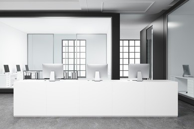 modern white office interior with a concrete floor, a long white reception desk and an open space area in the background. 3d rendering mock up