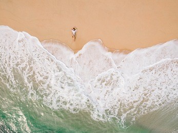 aerial view.top view.beautiful woman wearing bikini taking.happy and enjoying beach relaxing joyful in summer by tropical blue water.a sexy young girl.holiday person.amazing sea nature background.