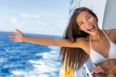 cruise vacation on cruise travel holiday in caribbean beach. asian girl with open arm in freedom happy excited. tourist woman screaming of joy. happy traveler having fun on summer vacations.