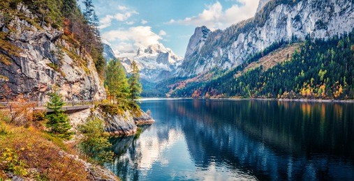 colorful autumn panorama of vorderer ( gosausee ) lake with dachstein glacier on background. splendid morning view of austrian alps, upper austria, europe. orton effect.