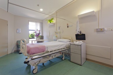 hospital ward with bed and medical equipment