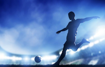 football, soccer match. a player shooting on goal. lights on the stadium at night.