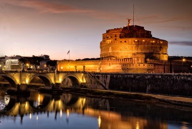 sant' angelo castle and tiber river in rome, italy by night