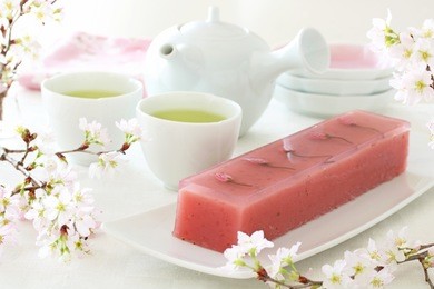 japanese traditional spring sweet, sweet bean jelly with cherry blossoms  on white plate