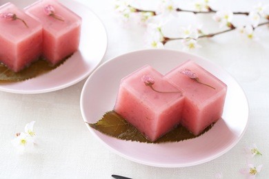 japanese traditional spring sweet, sweet bean jelly with cherry blossoms  on pale pink plate