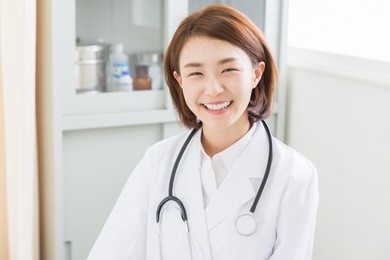 young attractive asian woman in a white coat