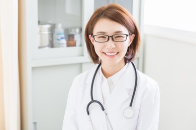 young attractive asian woman in a white coat