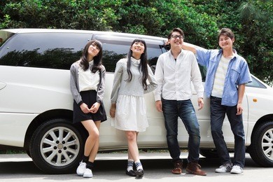 japanese students standing in front of car
