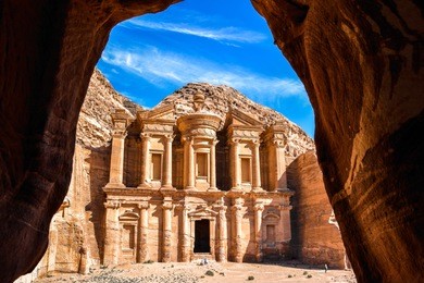 stunning view from a cave of the ad deir - monastery in the ancient city of petra, jordan: incredible unesco world heritage site.