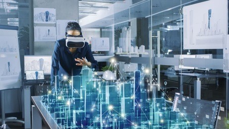 professional female architect wearing  augmented reality headset work with 3d city model. high tech office use virtual reality modeling software application.