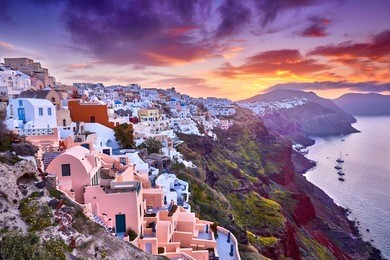 multicolored clouds of the morning dawn. fira town on santorini island, greece. incredibly romantic sunrise on santorini. oia village in the morning light. amazing sunset view with white houses.