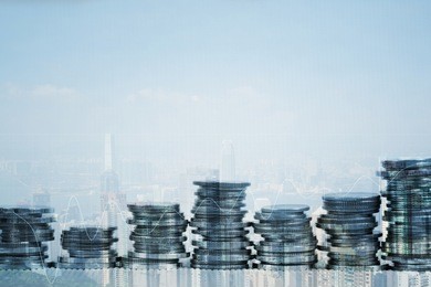 double exposure stack of coin with financial graph over city and office building background, business and financial concept idea.