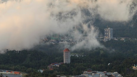 aerial view of rolling clouds over buildings, city, genting highlands, pahang