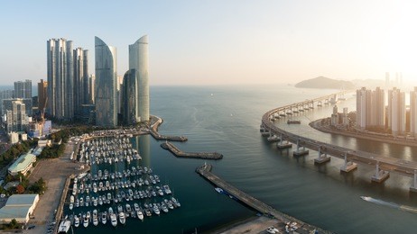 panorama of busan city skyline view at haeundae district, gwangalli beach with yacht pier at busan, south korea.