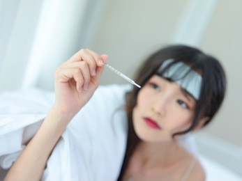 asian woman have a fever