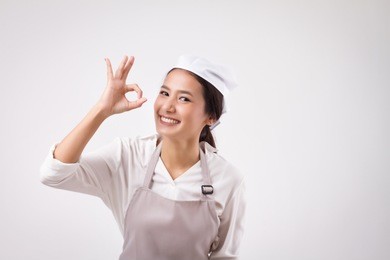happy smiling asian woman pointing accepting yes good ok okay hand gesture, domestic worker pointing ok sign, woman housekeeper, girl shopkeeper, girl cleaner, housewife pointing ok hand symbol