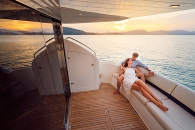 romantic vacation and luxury travel. young loving couple sitting on the sofa on the modern yacht deck. sailing the sea.