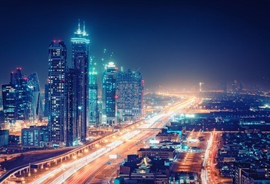 spectacular nighttime skyline of a big modern city at night
. dubai, uae. aerial view on highways and skyscrapers.