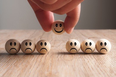 hand putting on a smiling wooden ball, concept of recruiting