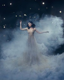 an attractive goddess stands in the clouds in a luxurious, gold, sparkling dress. whimsical hairstyle. against the backdrop of a star and space. artistic photography