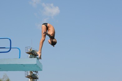 diving jn springboard 3m of a young athlete in city