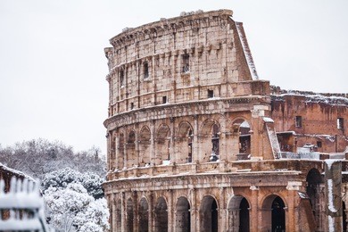 a lovely day of snow in rome, italy, 26th february 2018: a beautiful view of colosseum under the snow
