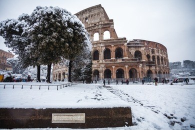 a lovely day of snow in rome, italy, 26th february 2018: a beautiful view of colosseum under the snow