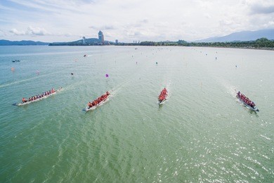 aerial view of a group of dragon boat paddler practice at likas bay sabah malaysia. dragon boat competition is an annual event in sabah malaysia.