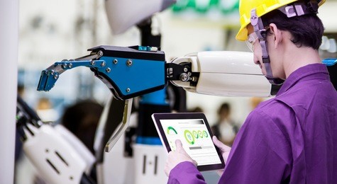 industry 4.0 robot concept .engineers use laptop computers for machine maintenance, automation tools, robot arm at the factory.
