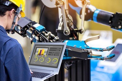 industry 4.0 robot concept .engineers use laptop computers for machine maintenance, automation tools, robot arm at the factory.
