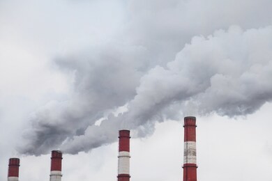 pollution of the nature, pipes with gray smoke in the sky