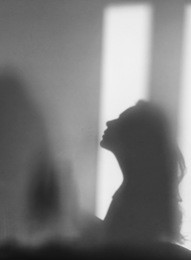 shadow of girl looking up on the white wall background