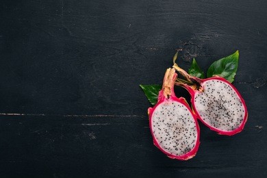 dragon fruit. tropical fruits. on a wooden background. top view. copy space.