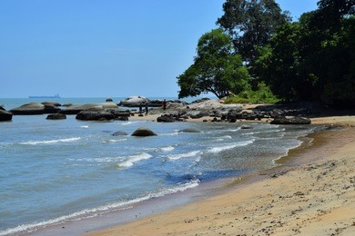 waves of the strait of malacca sea hitting the shores of tanjung bidara beach, malacca, malaysia. 