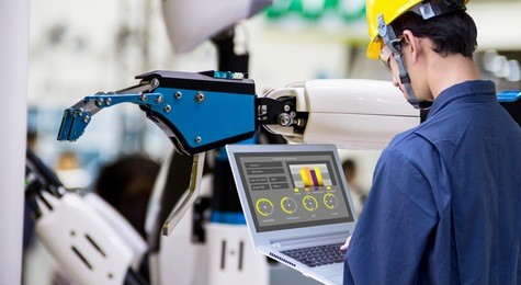 industry 4.0 robot concept .engineers use laptop computers for machine maintenance, automation tools, robot arm at the factory.
