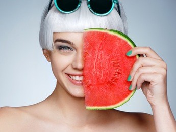 lovely girl holding red ripe watermelon slice. healthy & happy