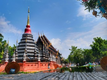 wat phan tao is a beautiful wooden temple, thai temple reflecting in water, public area