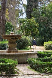 very nice fountain in the maria luisa park in sevilla, spain. concept of the end of rest. perfect day in orange garden.