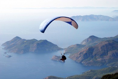flying paraglider in the sky, babadag, fethiye, turkey
